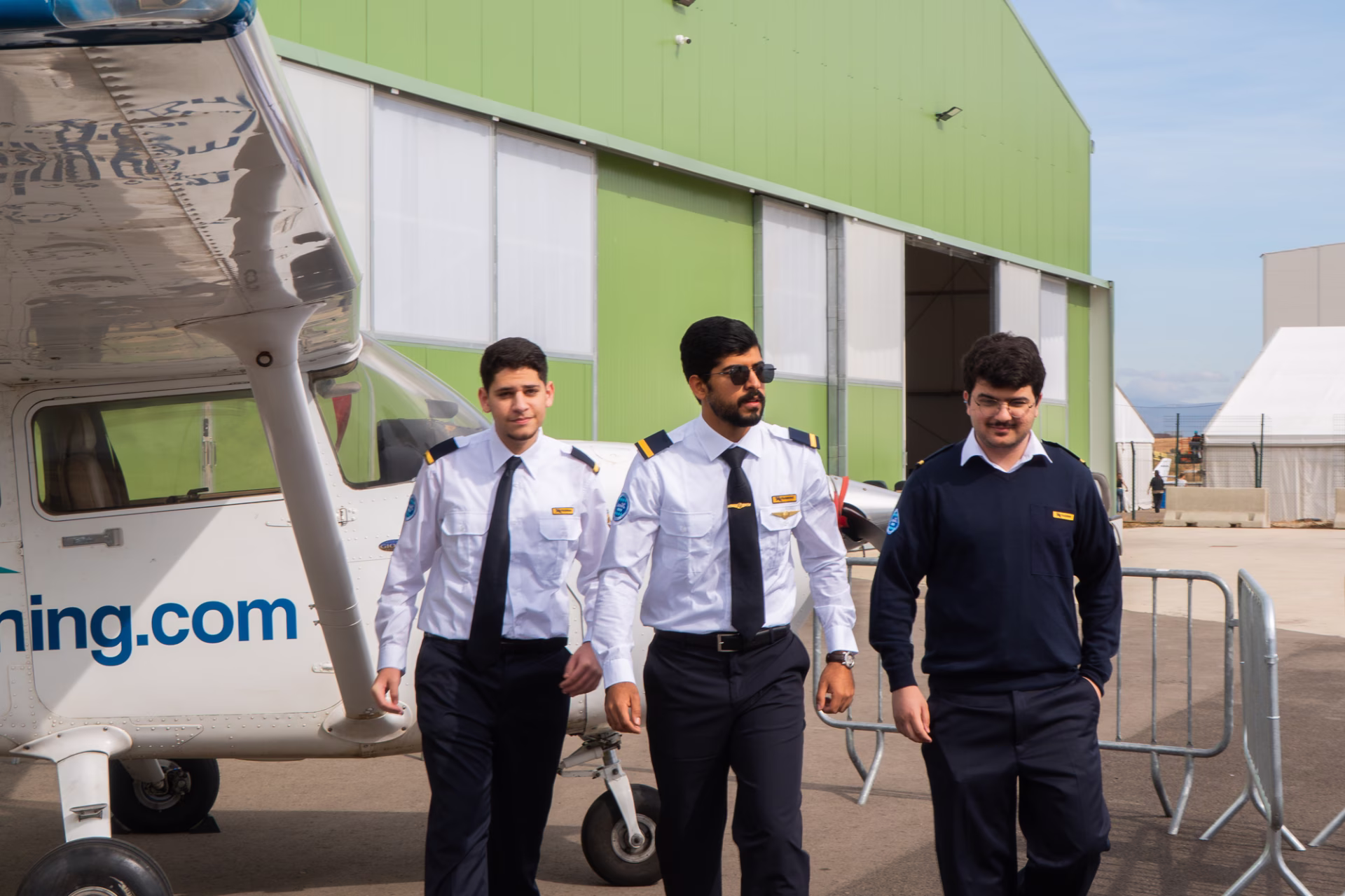 Three Jazeera Airways cadets next to a Cessna Skyhawk aircraft