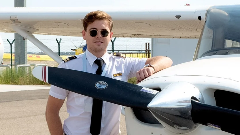 BAA Training Student next to plane