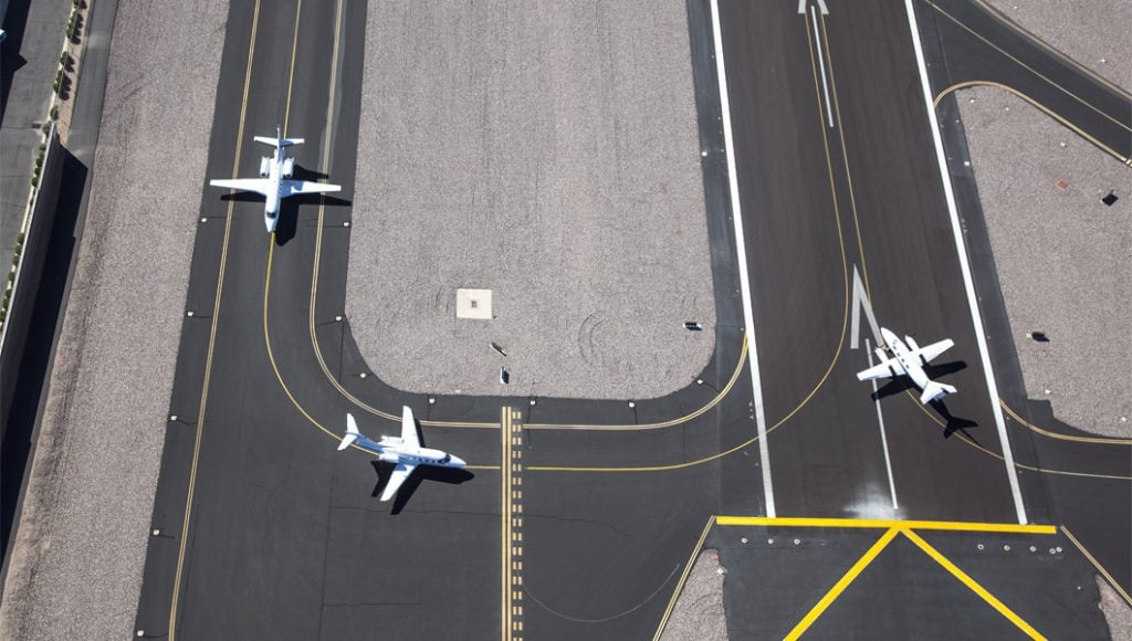 three airplanes on a taxiway
