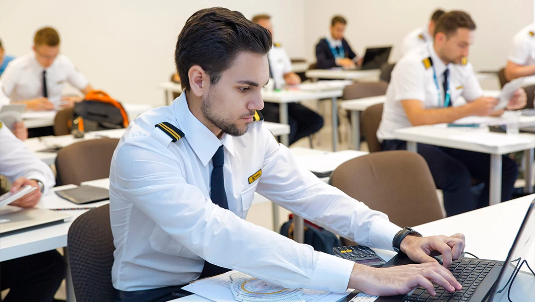 A pilot student sitting in a classroom.