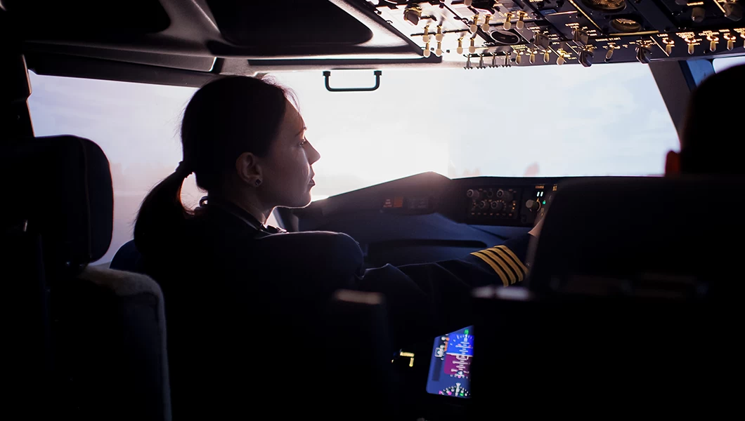 A female airline Captain piloting the airplane.