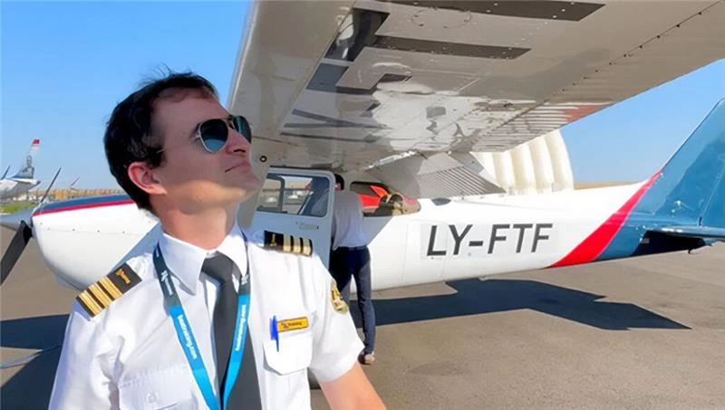 A flight instructor standing in front of a Cessna 172 Skyhawk aircraft