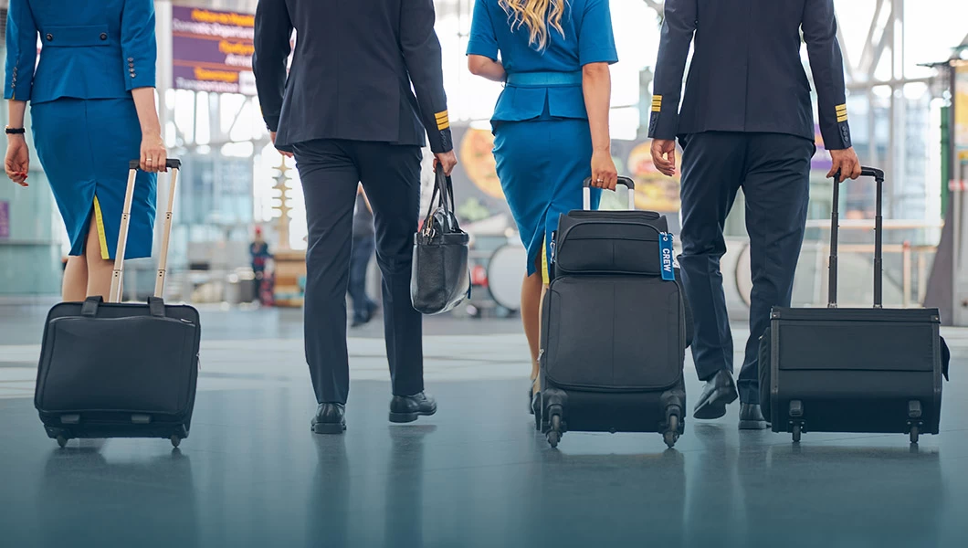 A commercial flight crew walking in an airport