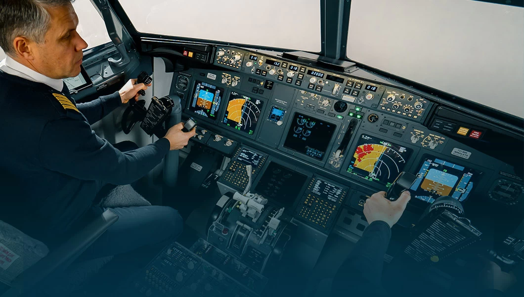 Two pilots in a full flight simulator cockpit in training