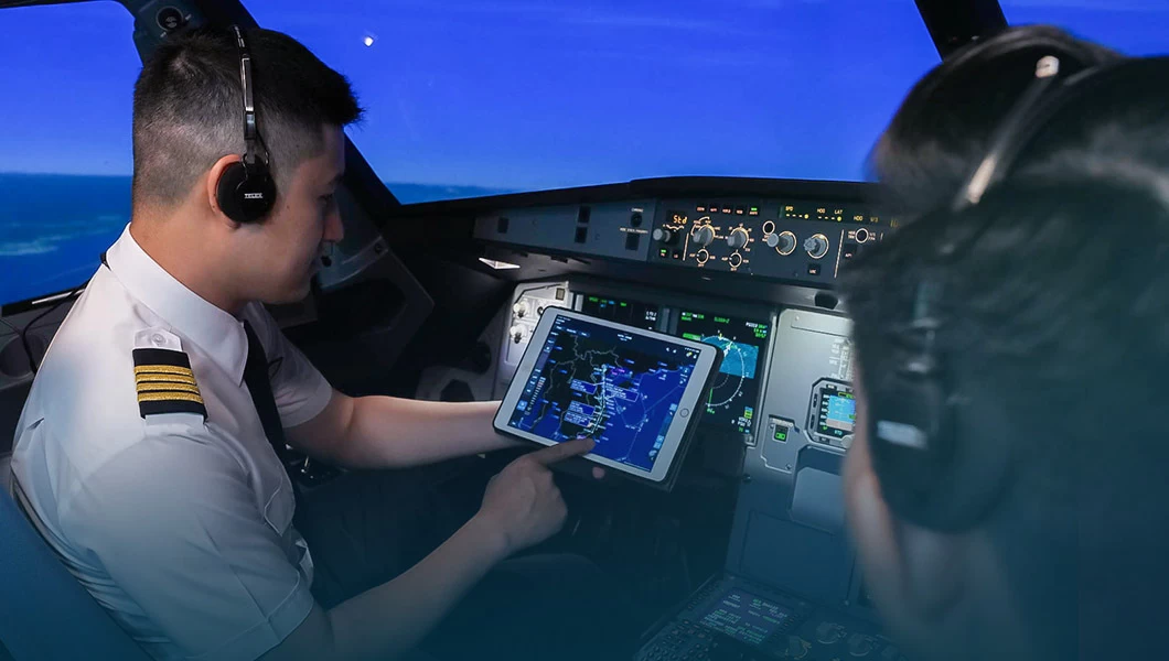 Two pilots in an aircraft full flight simulator cockpit