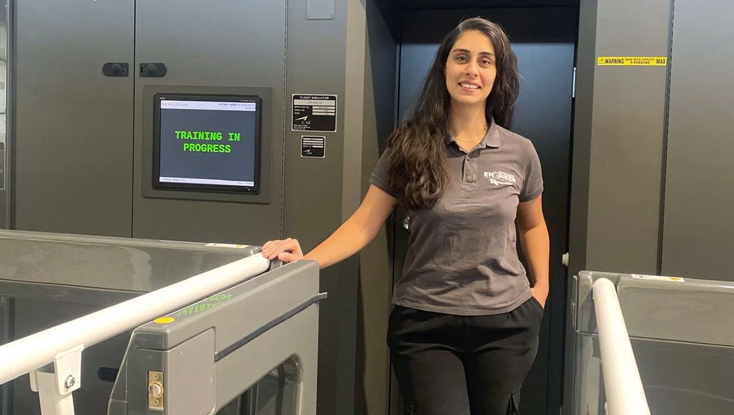 Aviation engineer next to a full flight simulator